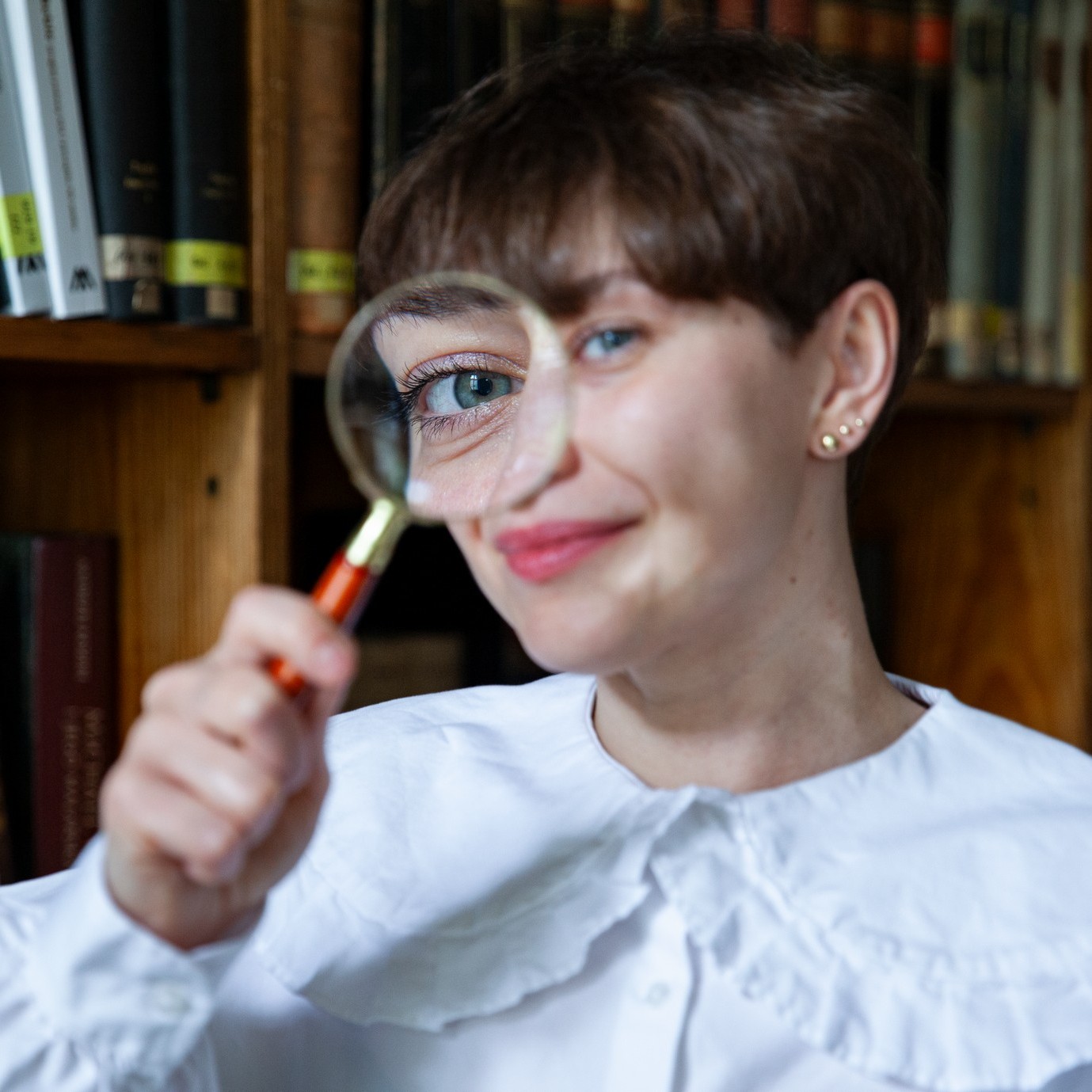 dr Karolina Rybicka patrzy przez szkło powiększające
